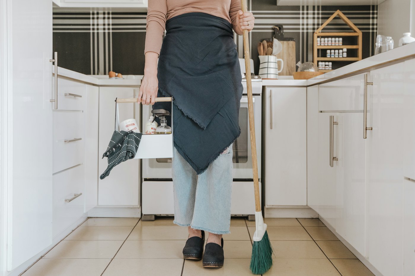 Cleaner sweeping a kitchen